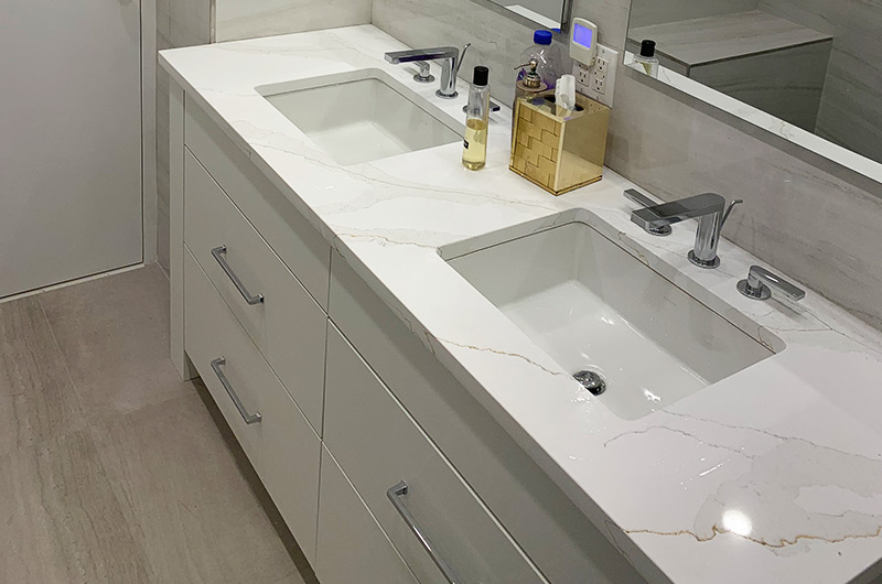 White double vanity with marble top and minimalist hardware