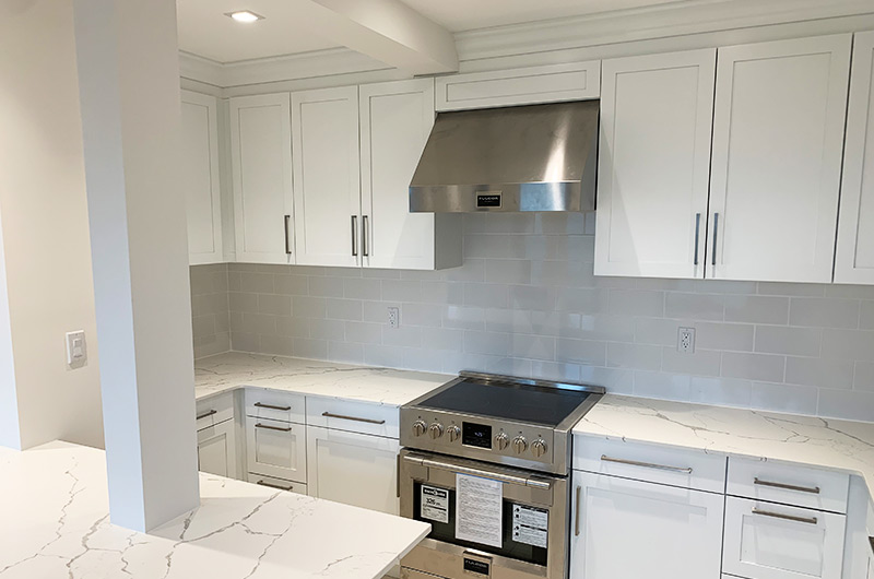 Custom kitchen island with veined marble top and storage drawers