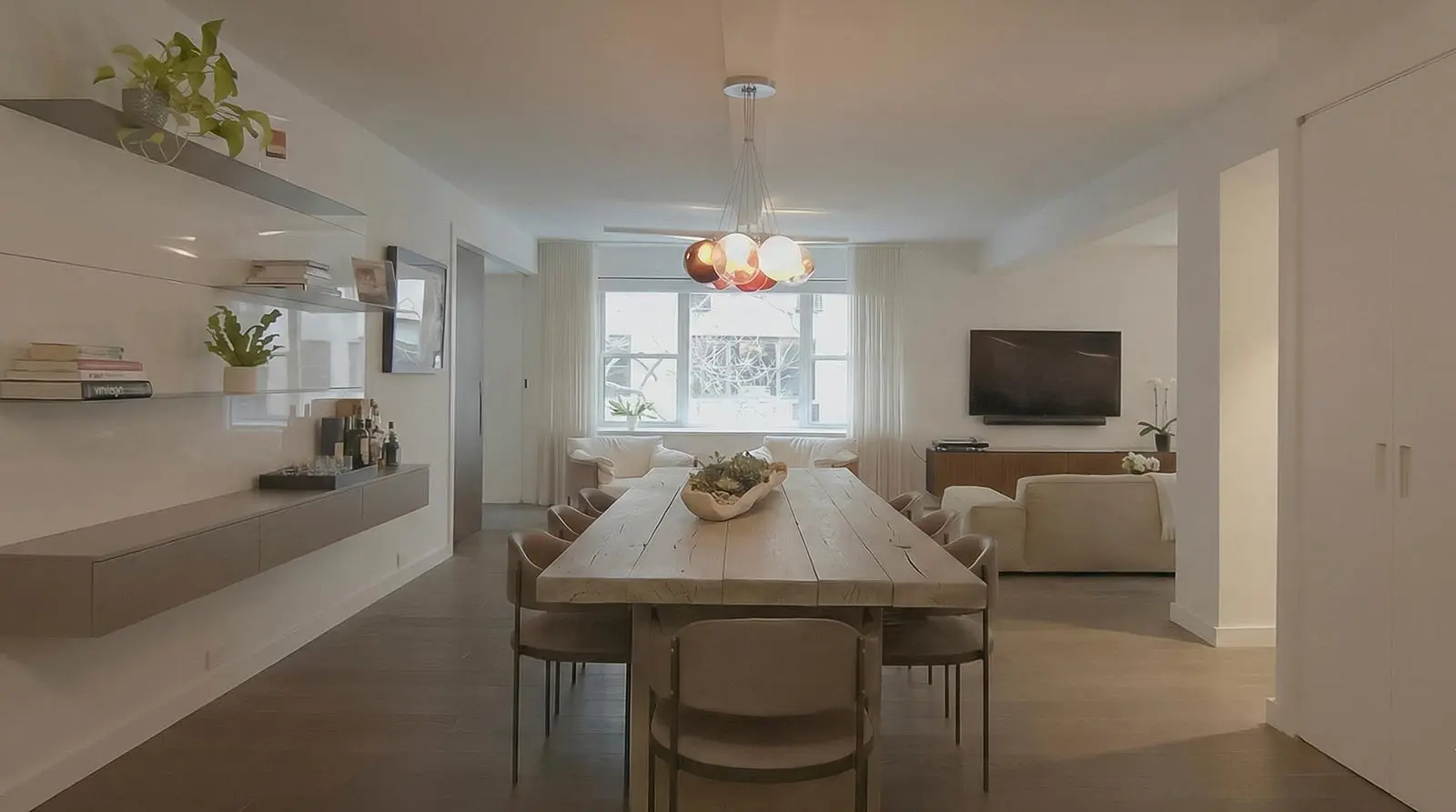 pre-war apartment renovation Upper East Side dining area with solid wood table and open-plan living space